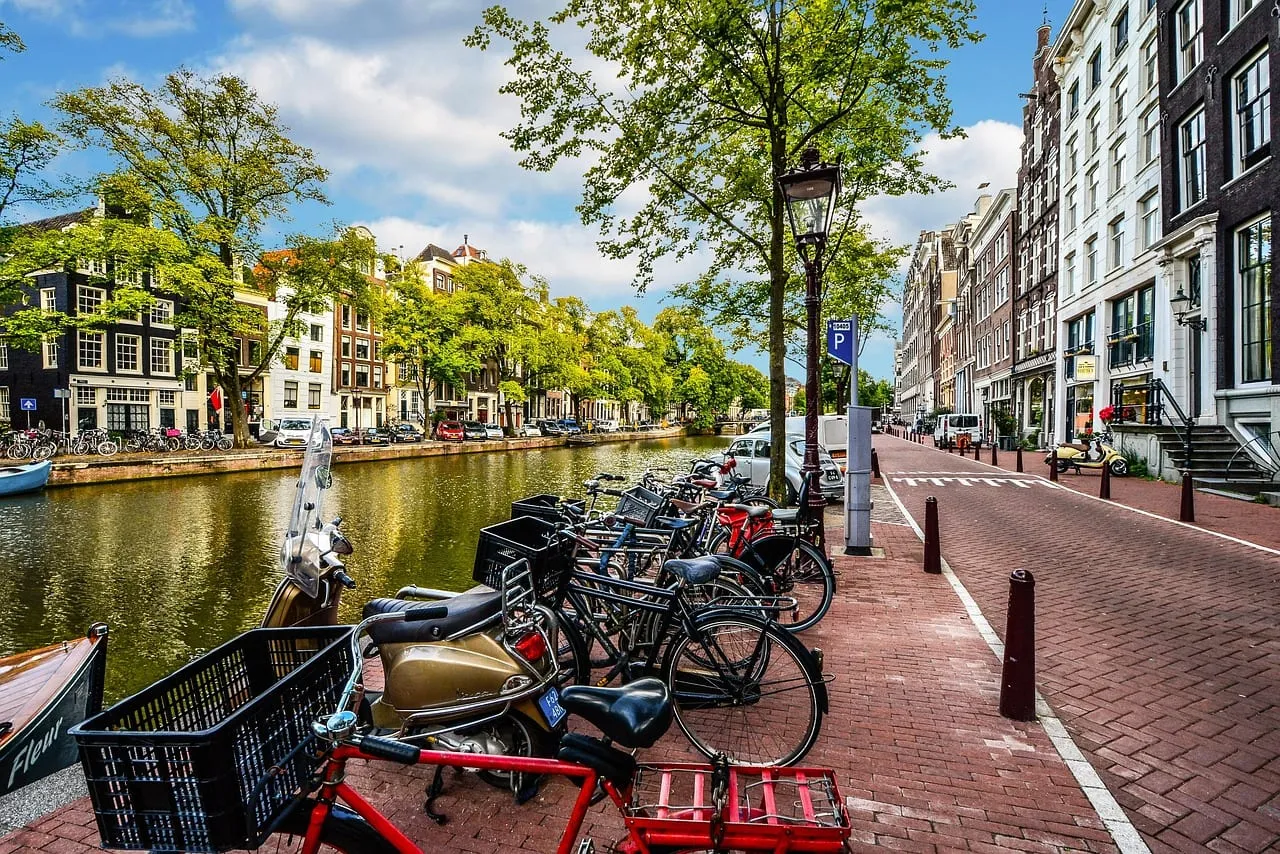 Bicycles parked along a canal on a sunny day