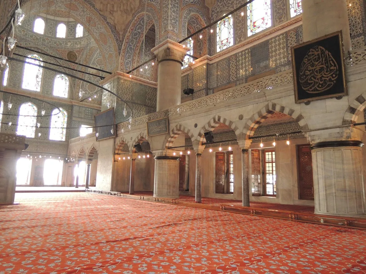 The prayer hall with its tiles and hanging lamps