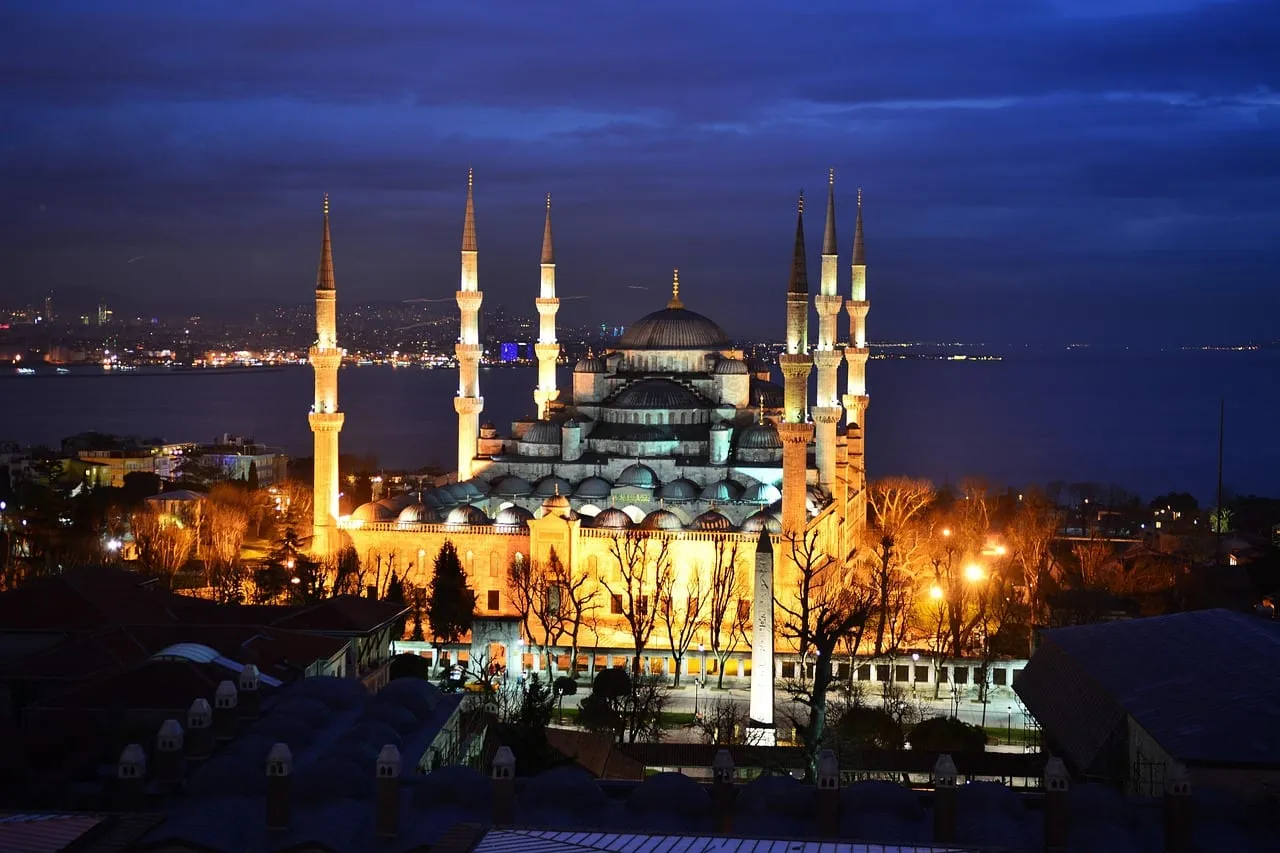 The mosque lit up at night above the Bosphorus