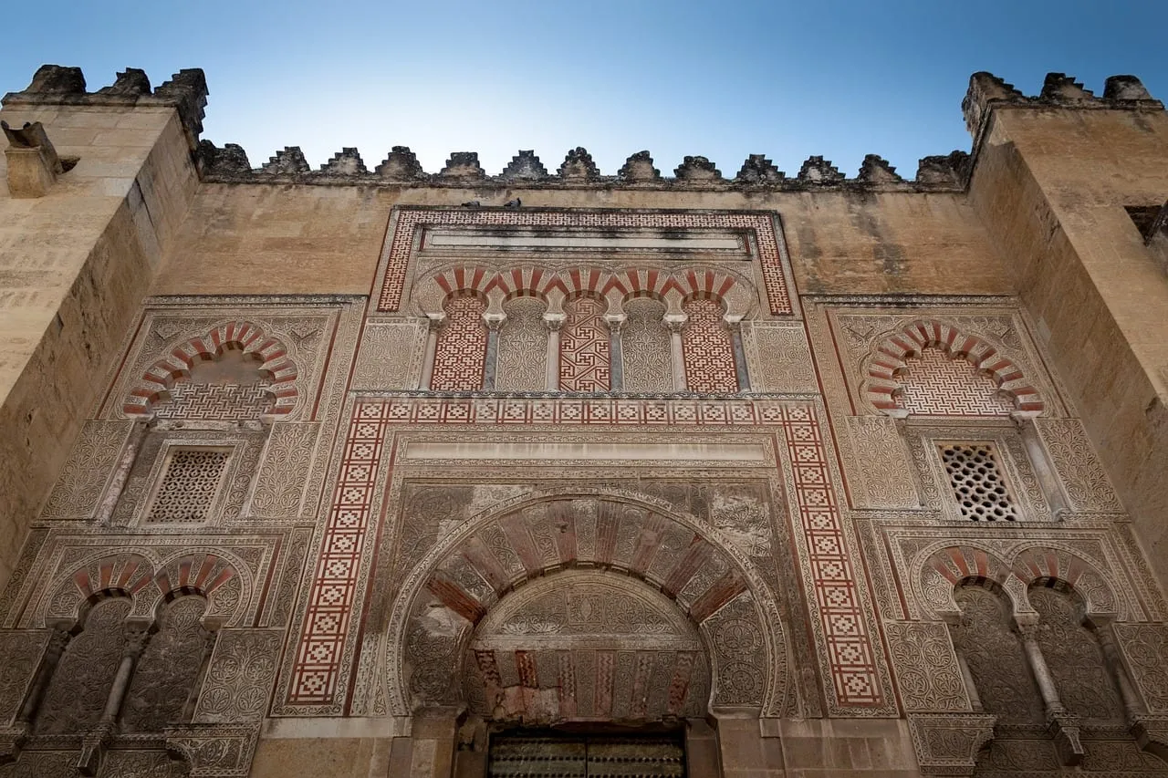 Carved stonework and horseshoe arches on an outer wall