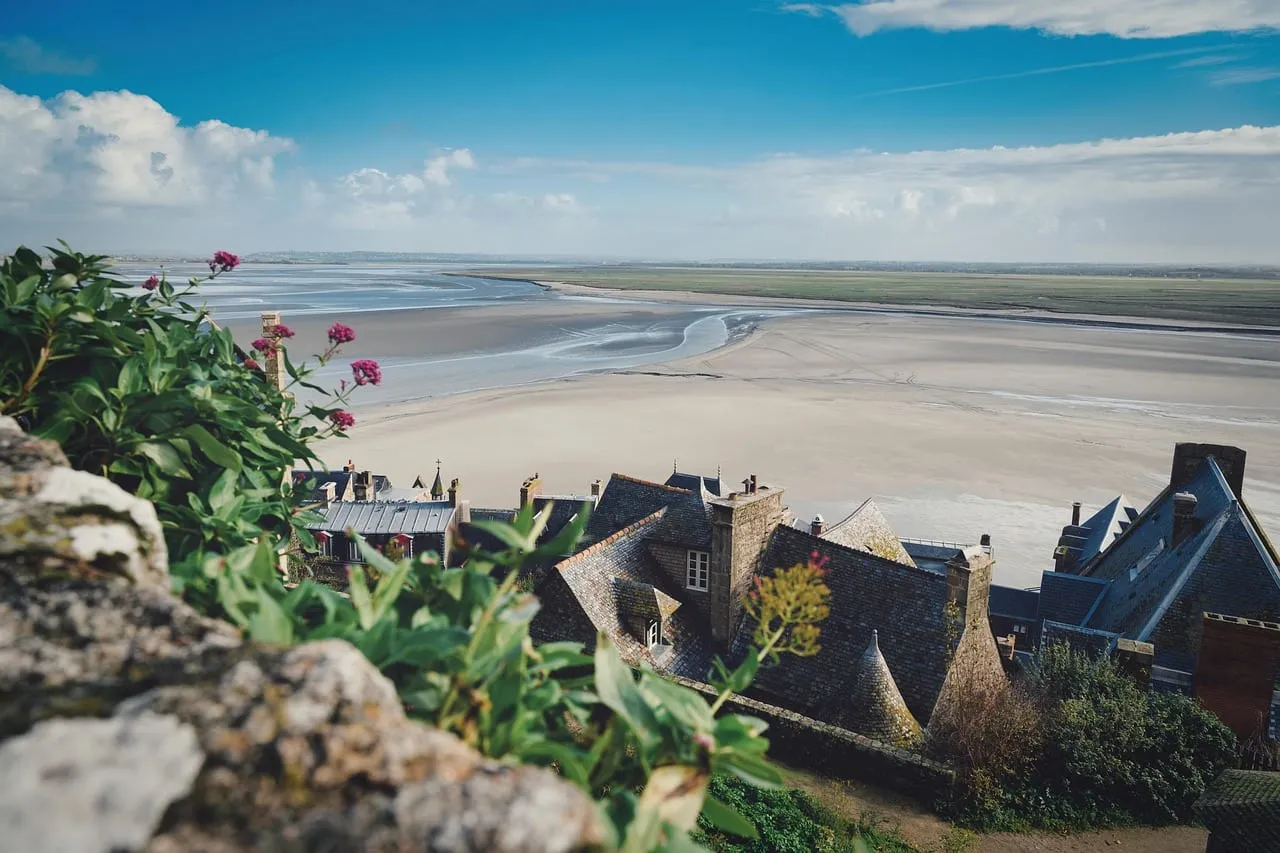 Slate roofs of the village and the sandy bay seen from up on the mount