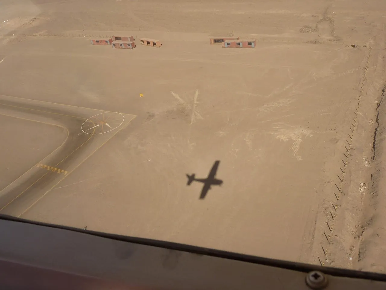 A small plane’s shadow over the airstrip