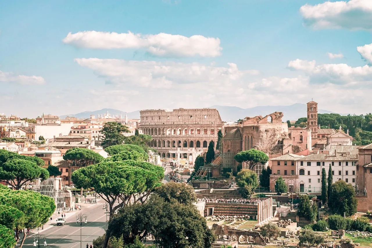 The Colosseum and the Roman Forum seen over pine trees