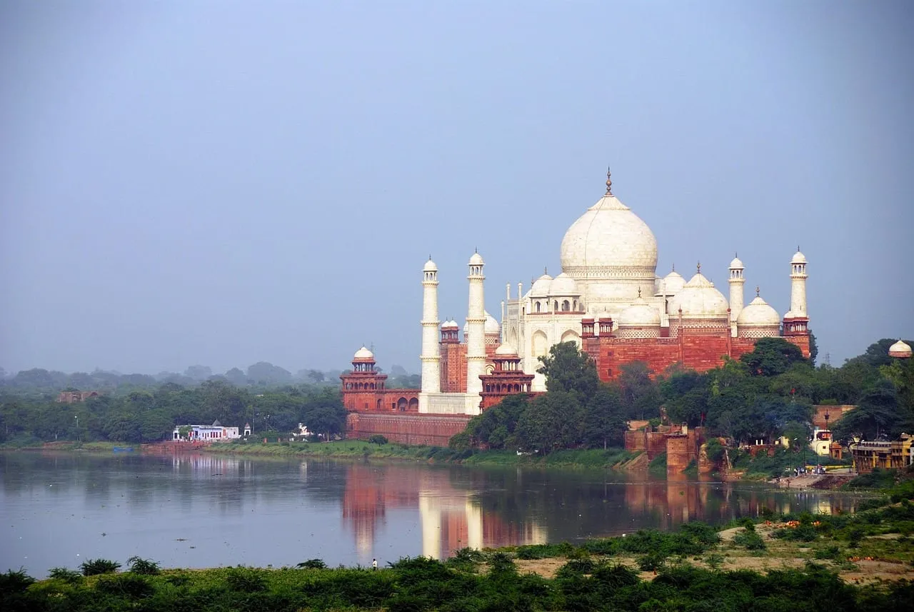 The Taj Mahal across the Yamuna river, with its red sandstone mosque