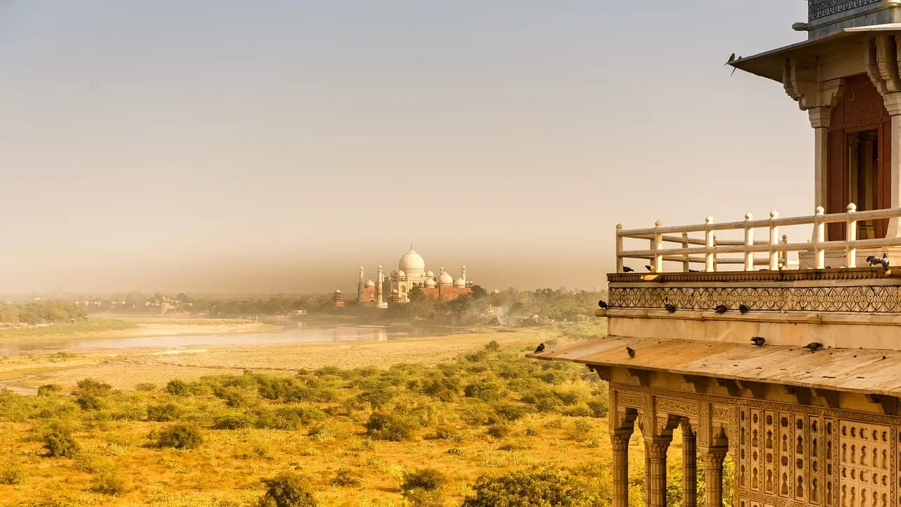 The Taj Mahal seen in the haze from a balcony across the river