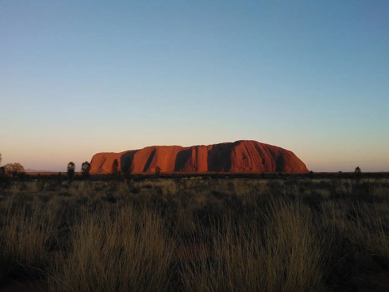 Uluru in silhouette at dusk
