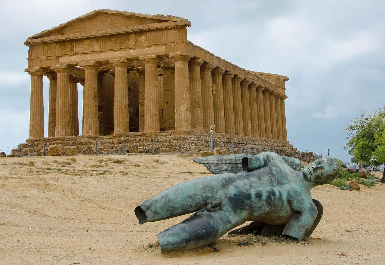 A fallen bronze figure in front of the Temple of Concordia